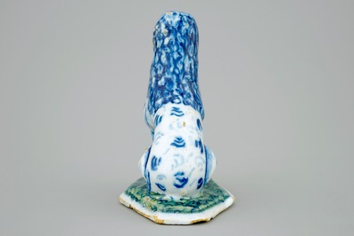 A Dutch Delft blue and white figure of a seated dog, 18th C.